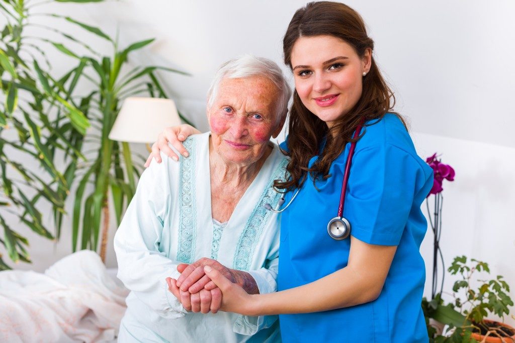 Old woman and nurse in a nursing home environment