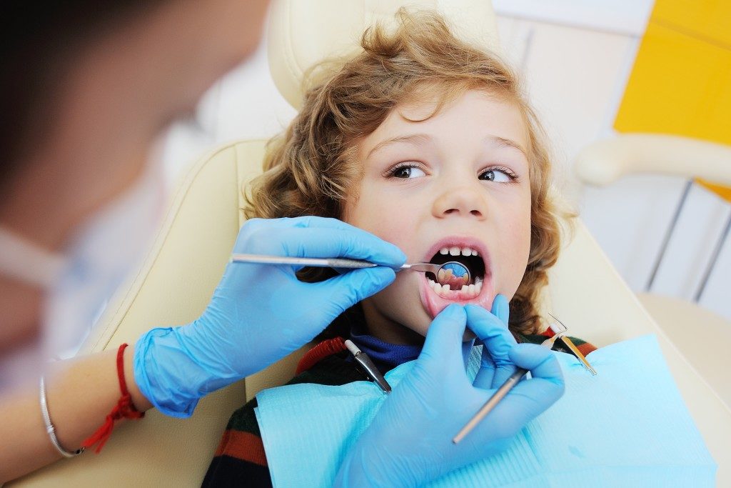 kid having his teeth checked