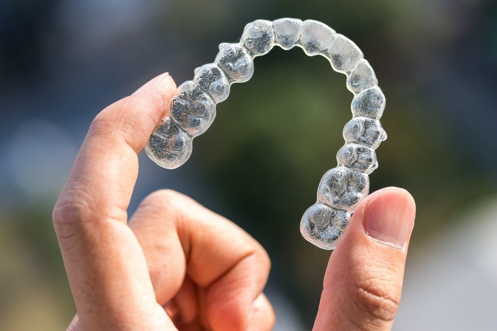 Person holding an invisalign