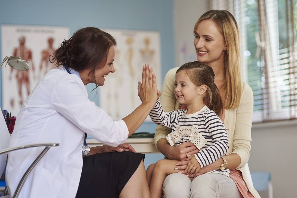 doctor giving a high five to young patient