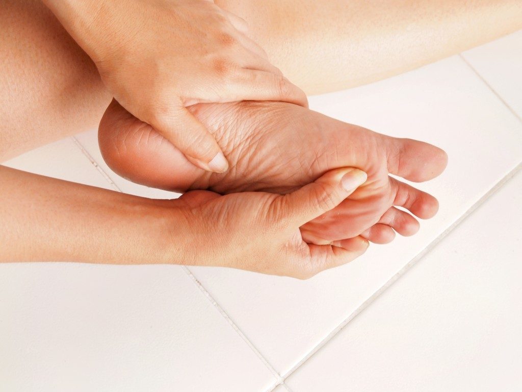 woman massaging her foot