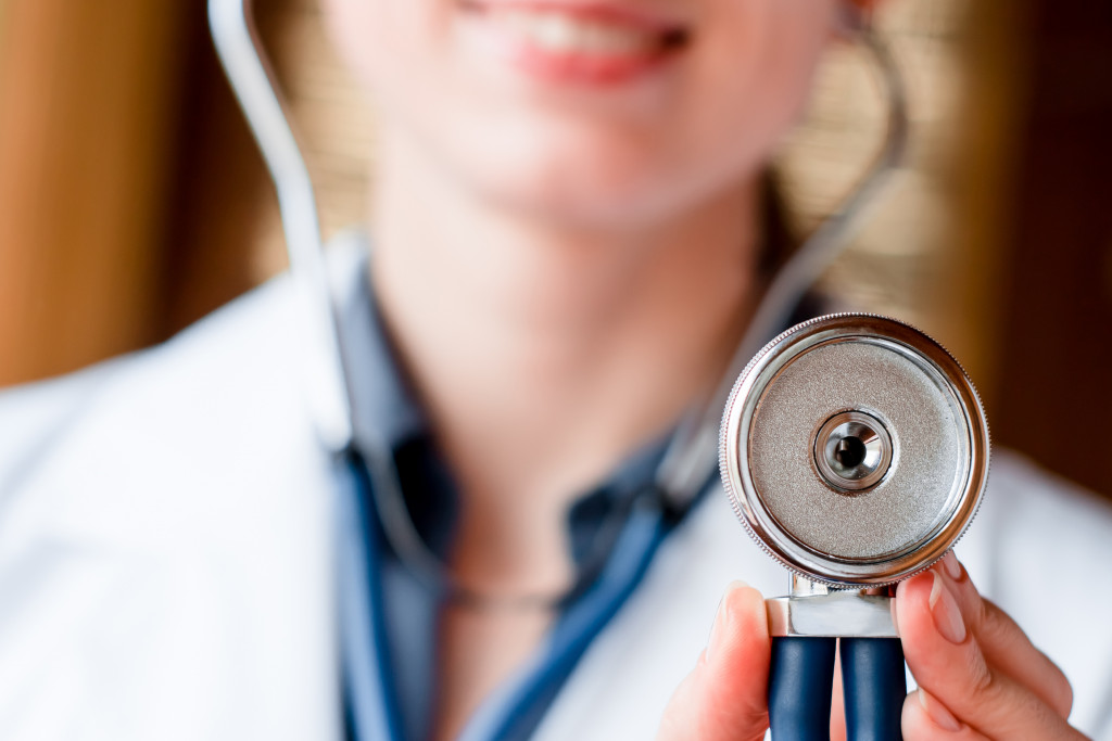 a doctor putting her stethoscope upwards, checking